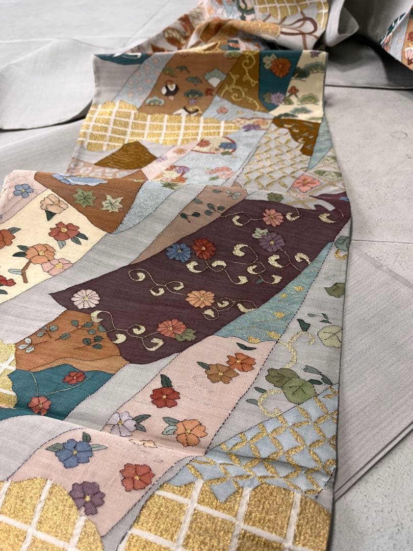 仕立て上がり新品袋帯　薄いグレーに鶴松花宝尽くしなどおめでたい柄　とても可愛い