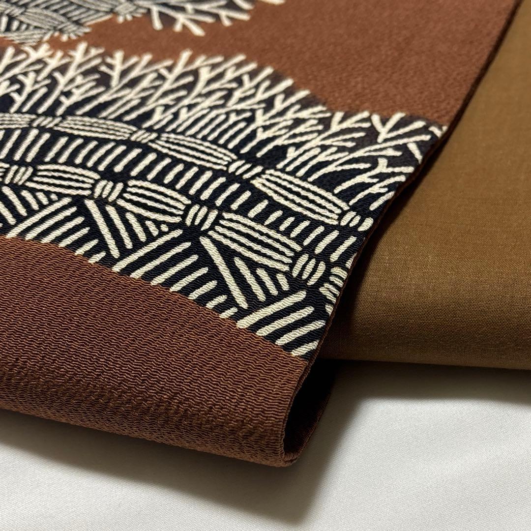 開き名古屋帯【栗山吉三郎】和染紅型 縮緬 垣根文様 茶色 お太鼓柄 正絹 九寸帯